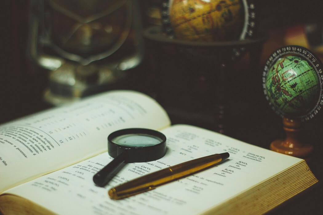 Book with globe on desk